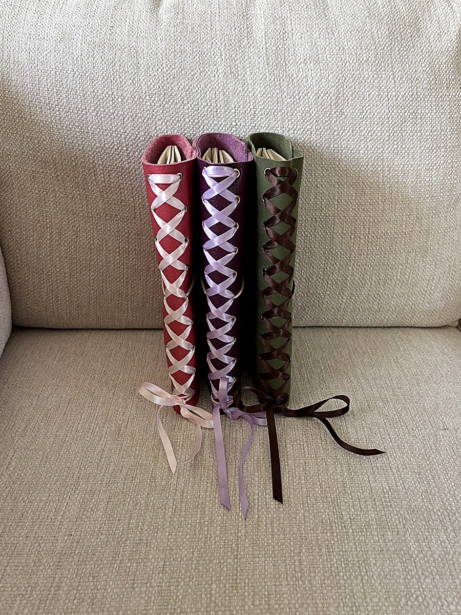 Dark chocolate journal with turquoise string on wood table