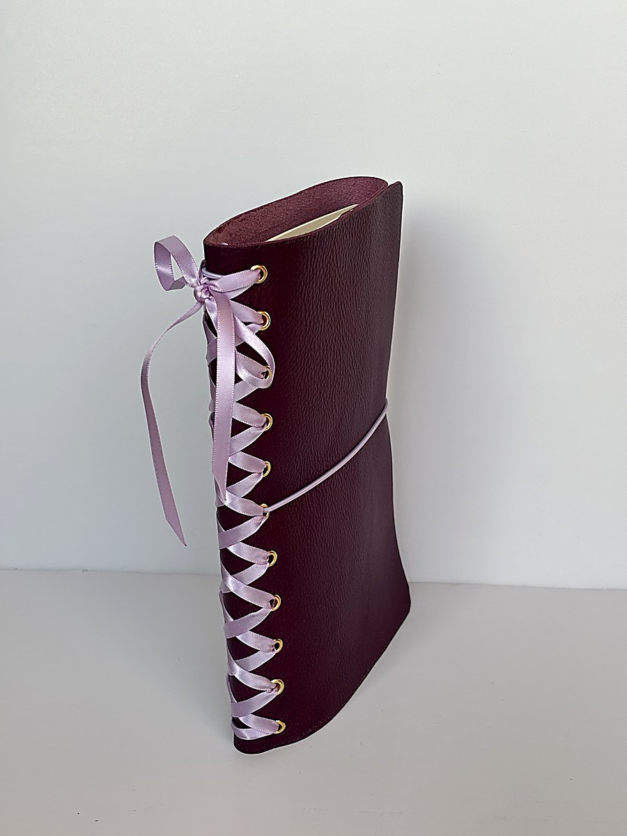 Chocolate journal with white lace ribbon held in hand