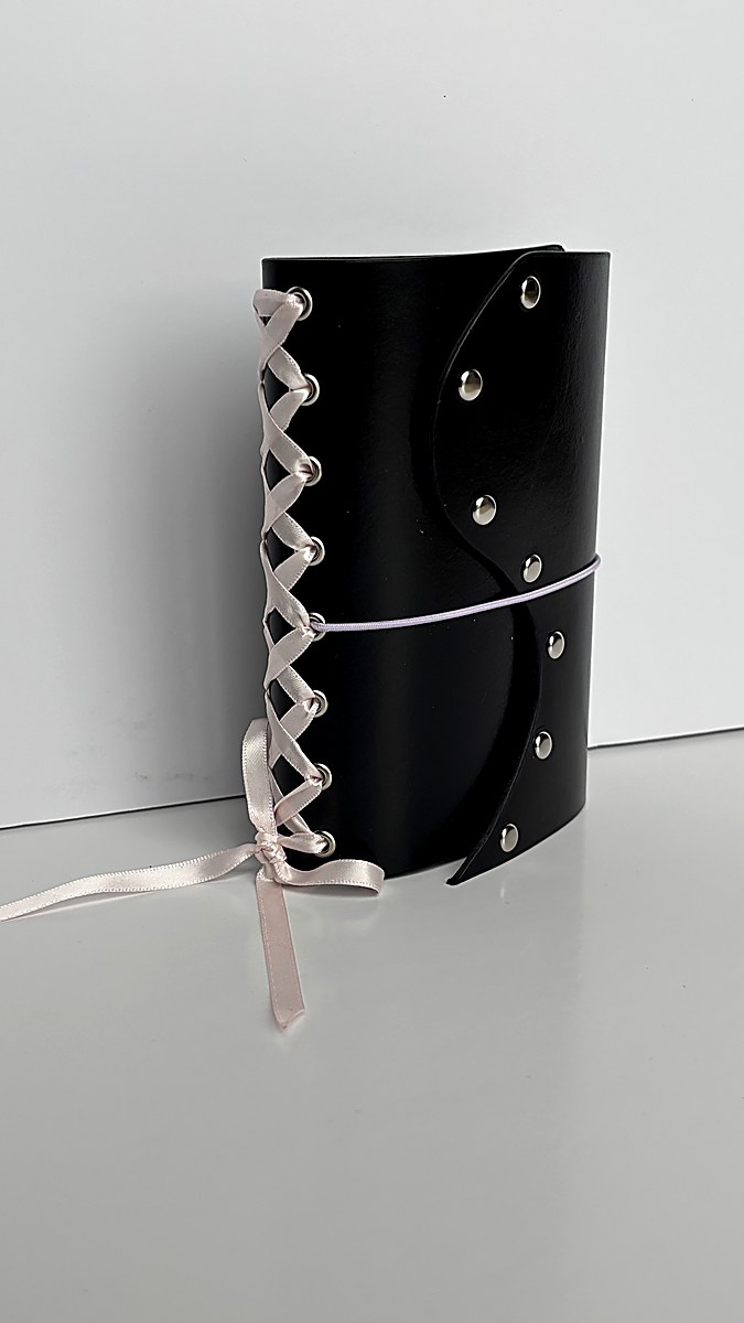 Chocolate journal with white lace ribbon flat lay