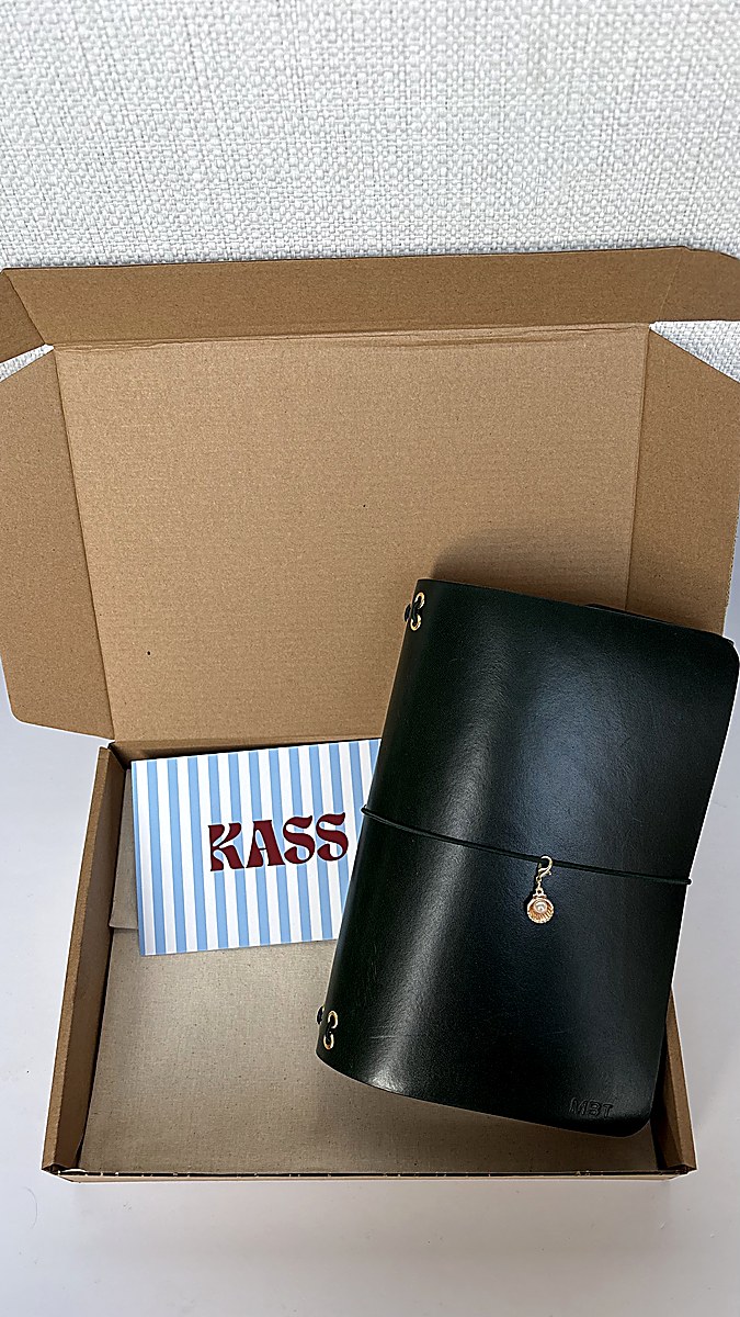 Red, burgundy, and olive green journal trio on couch